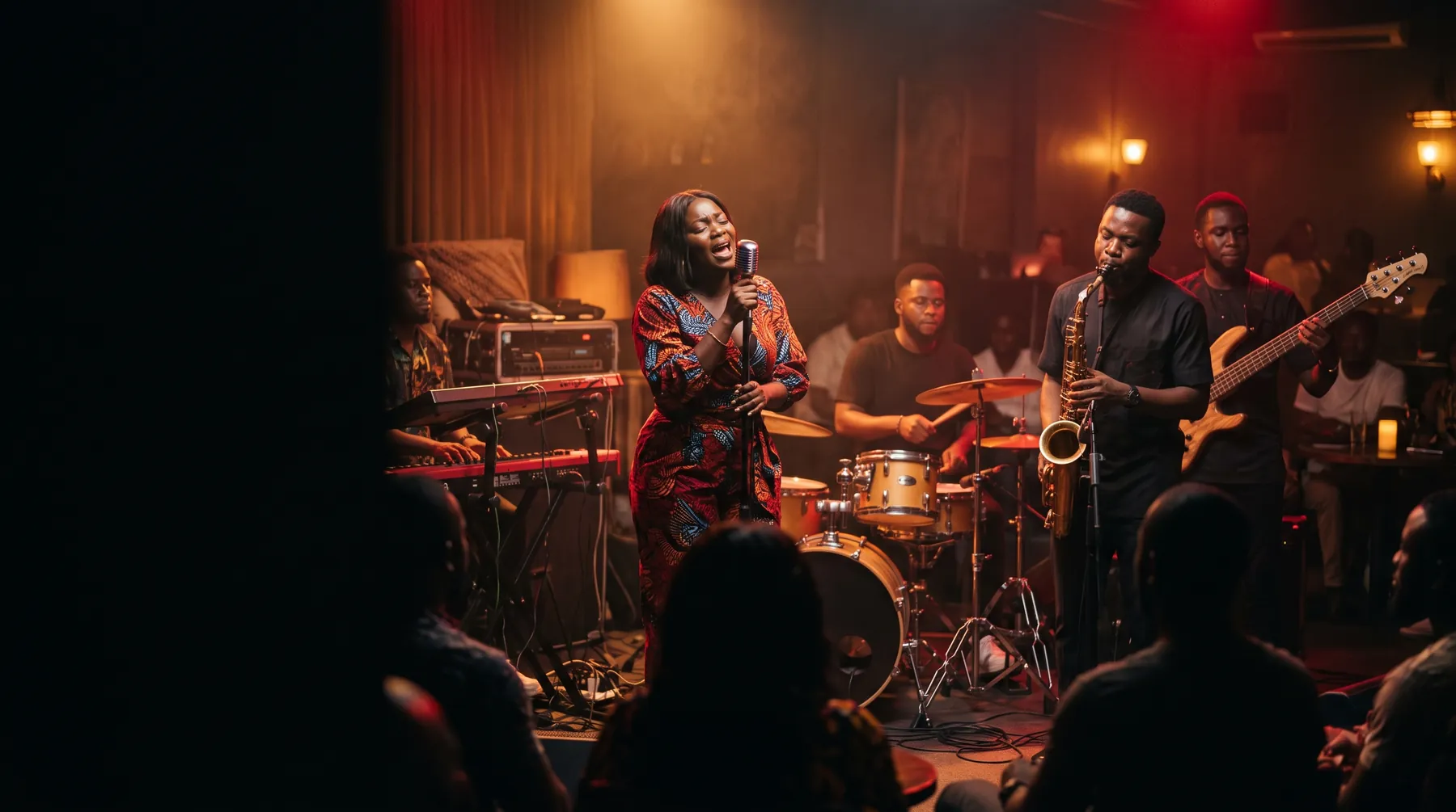 A live band performing on a small lounge stage with a vocalist and saxophonist